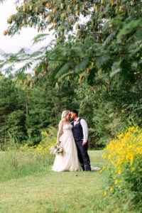 Wedding ceremony photography in high point NC with bride and groom kissing in the field