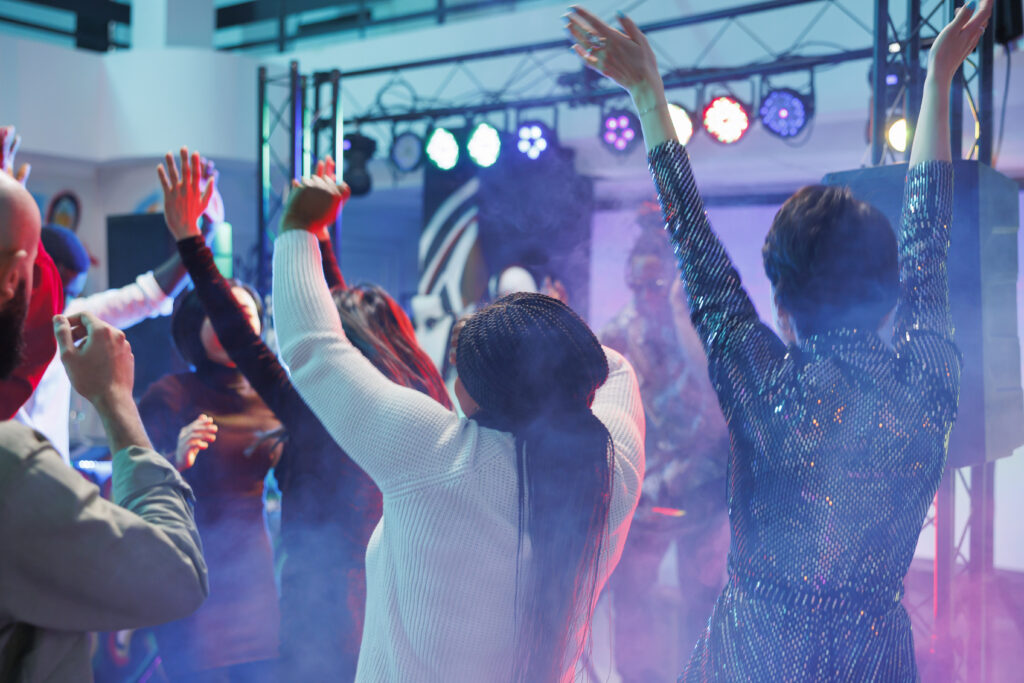 Party People with hands in the air at an event